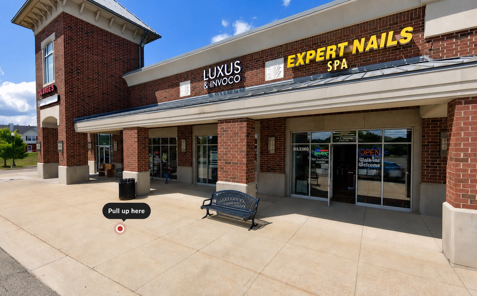 Luxus and Invoco storefront next to George's Restaurant